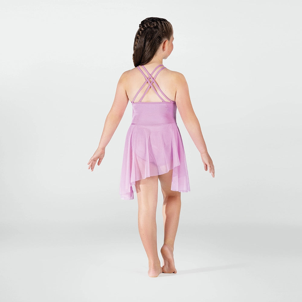 Young girl wearing a pink dress with thin straps on a white background