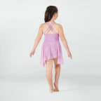 Young girl wearing a pink dress with thin straps on a white background