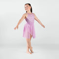 Young girl in a pink ballet dress posing on a white background