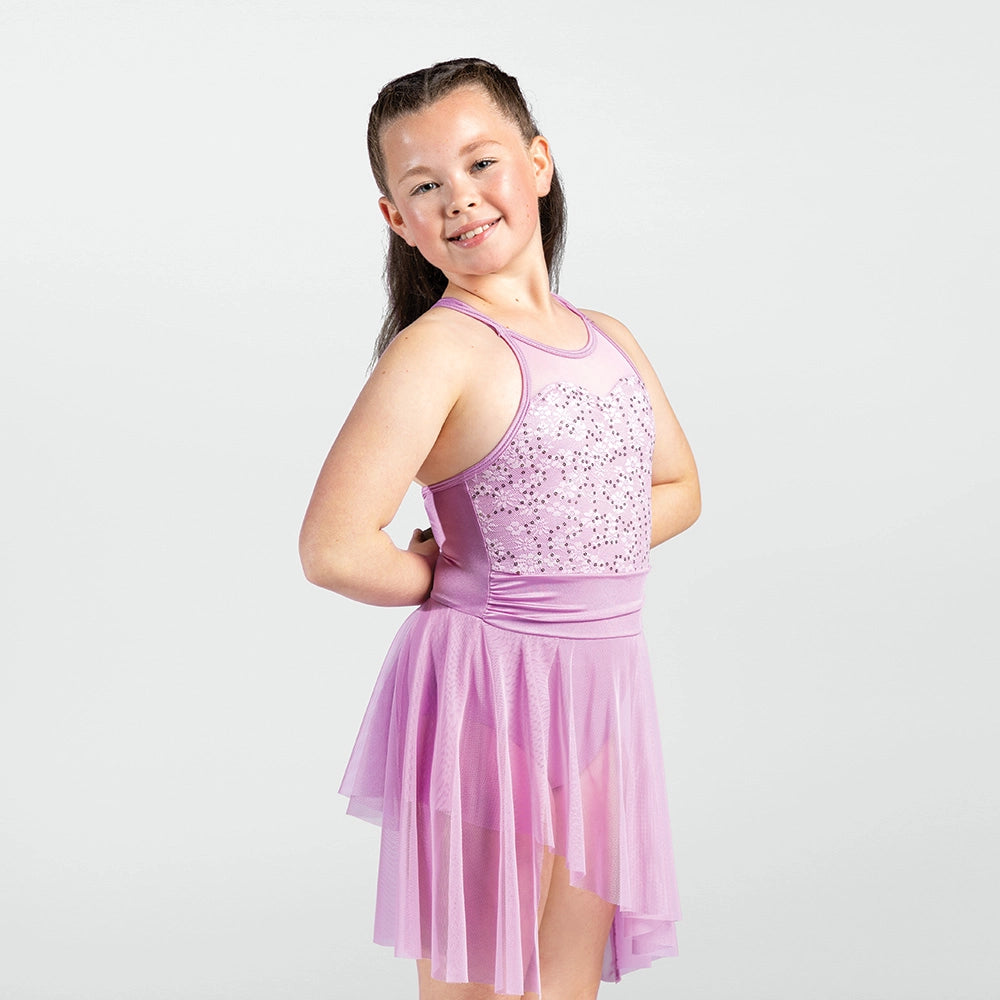 Young girl wearing a pink dress with sequin top on a white background