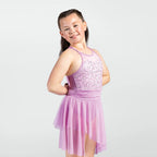 Young girl wearing a pink dress with sequin top on a white background