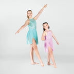 Two young dancers in pastel dance outfits posing against a white background