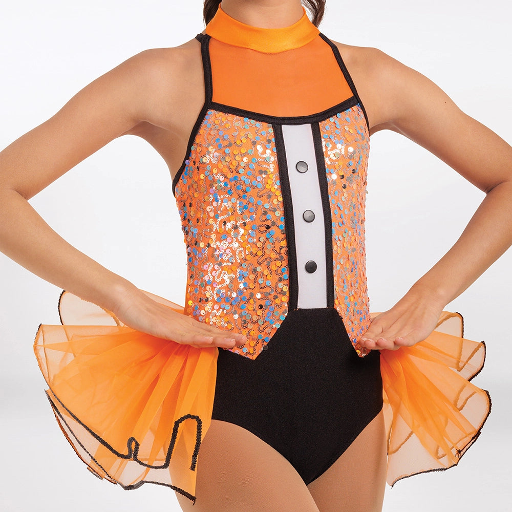 A close-up of a model wearing a bright orange and black dance leotard with sequined panels, a high orange collar, and a flared orange tulle skirt against a plain white background.