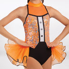 A close-up of a model wearing a bright orange and black dance leotard with sequined panels, a high orange collar, and a flared orange tulle skirt against a plain white background.