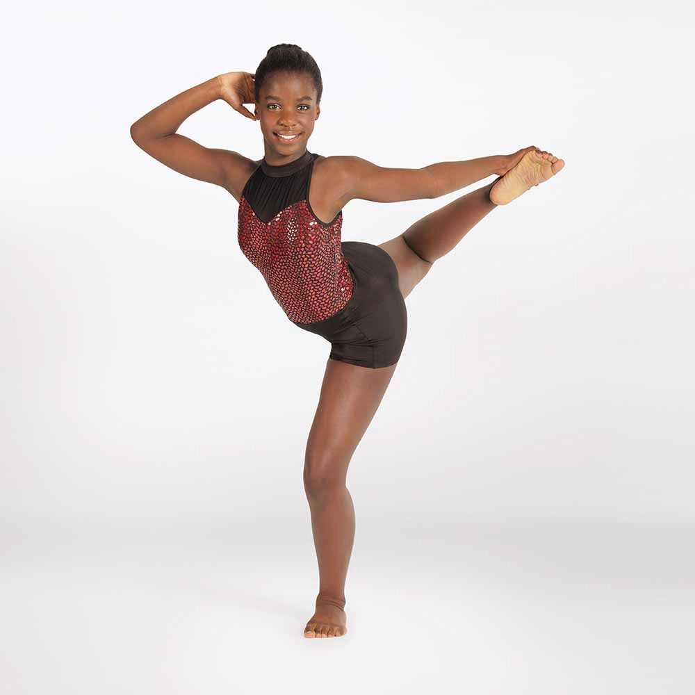Dancer in a red and black leotard posing on a white background