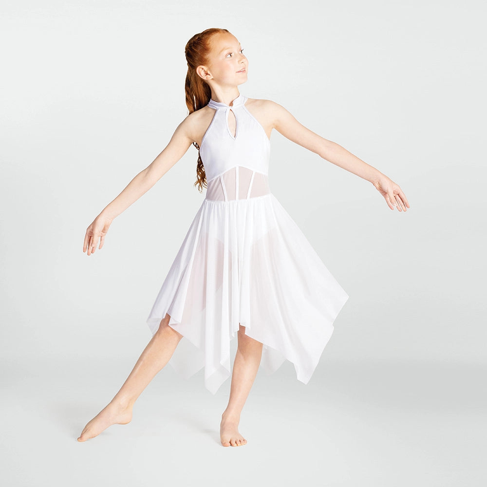 Young girl in a white dress posing against a plain background
