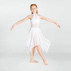 Young girl in a white dress posing against a light gray background