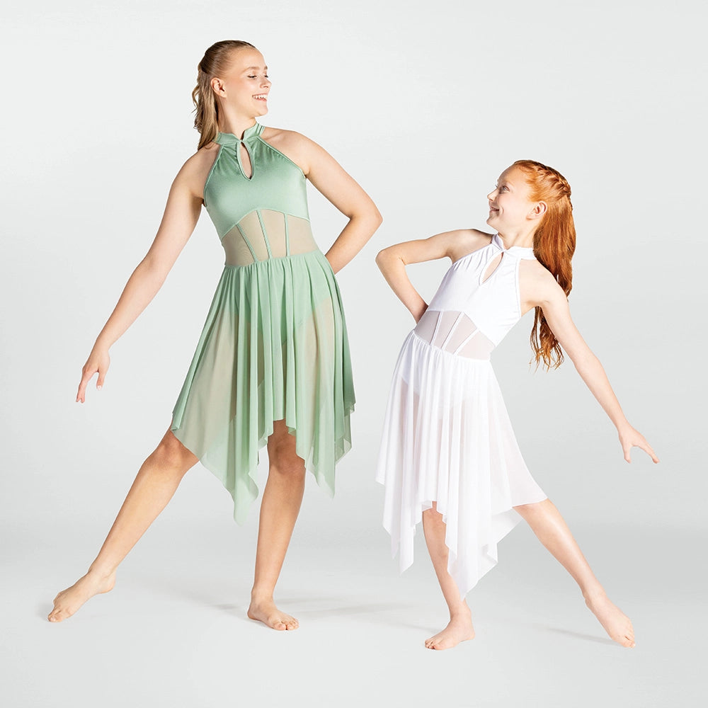 Two young girls in green and white dance dresses posing against a plain background