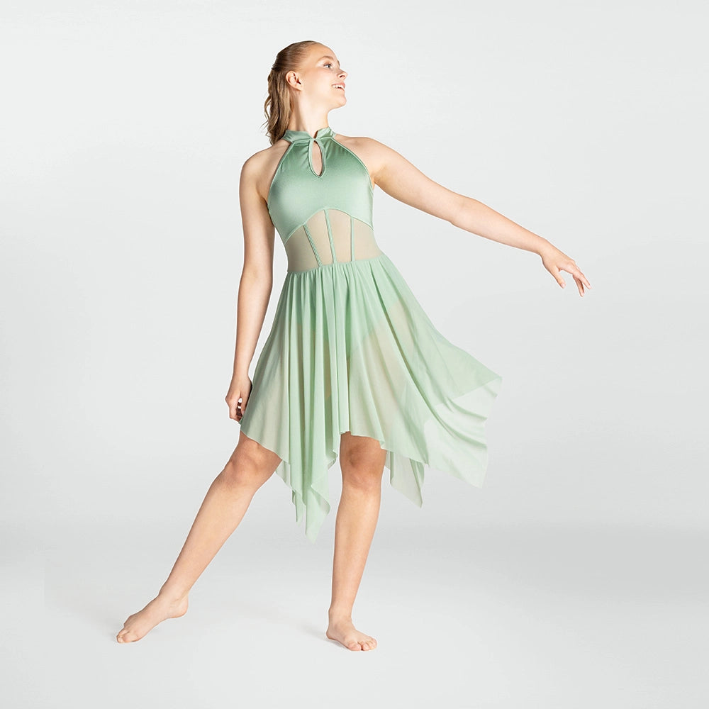 Woman wearing a light green dress with sheer panels on a white background