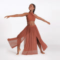 Woman in a rust-colored outfit with a flowing skirt on a white background
