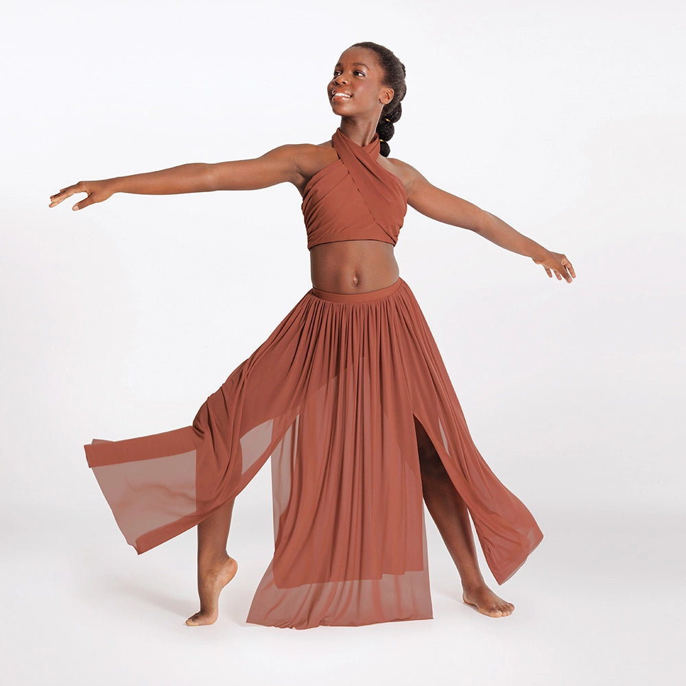 Woman in a rust-colored outfit with a flowing skirt on a white background