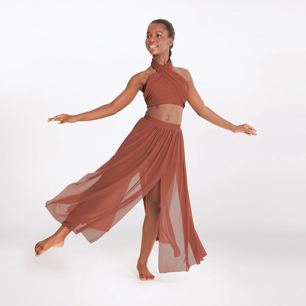 Woman in a rust-colored dress posing against a white background