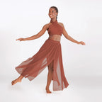 Woman in a rust-colored dress posing against a white background