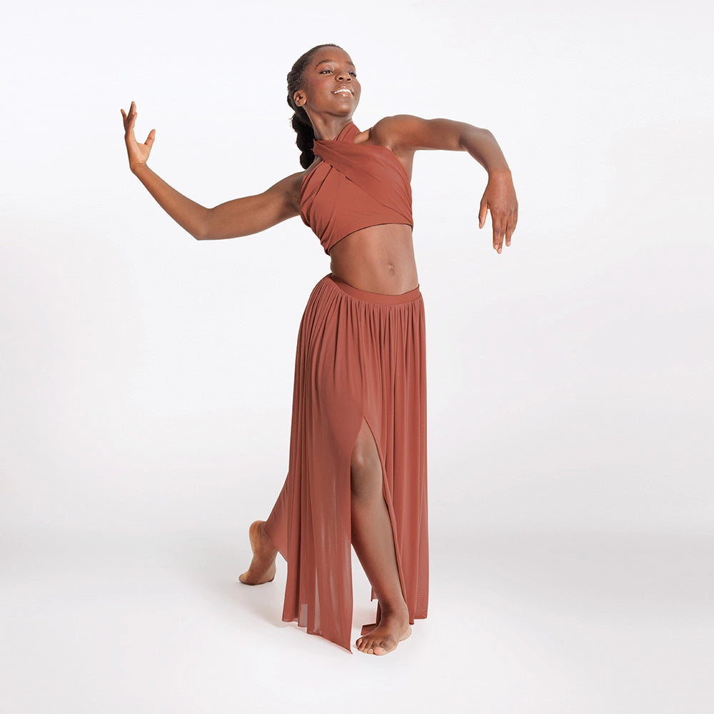 Dancer in a rust-colored outfit on a white background