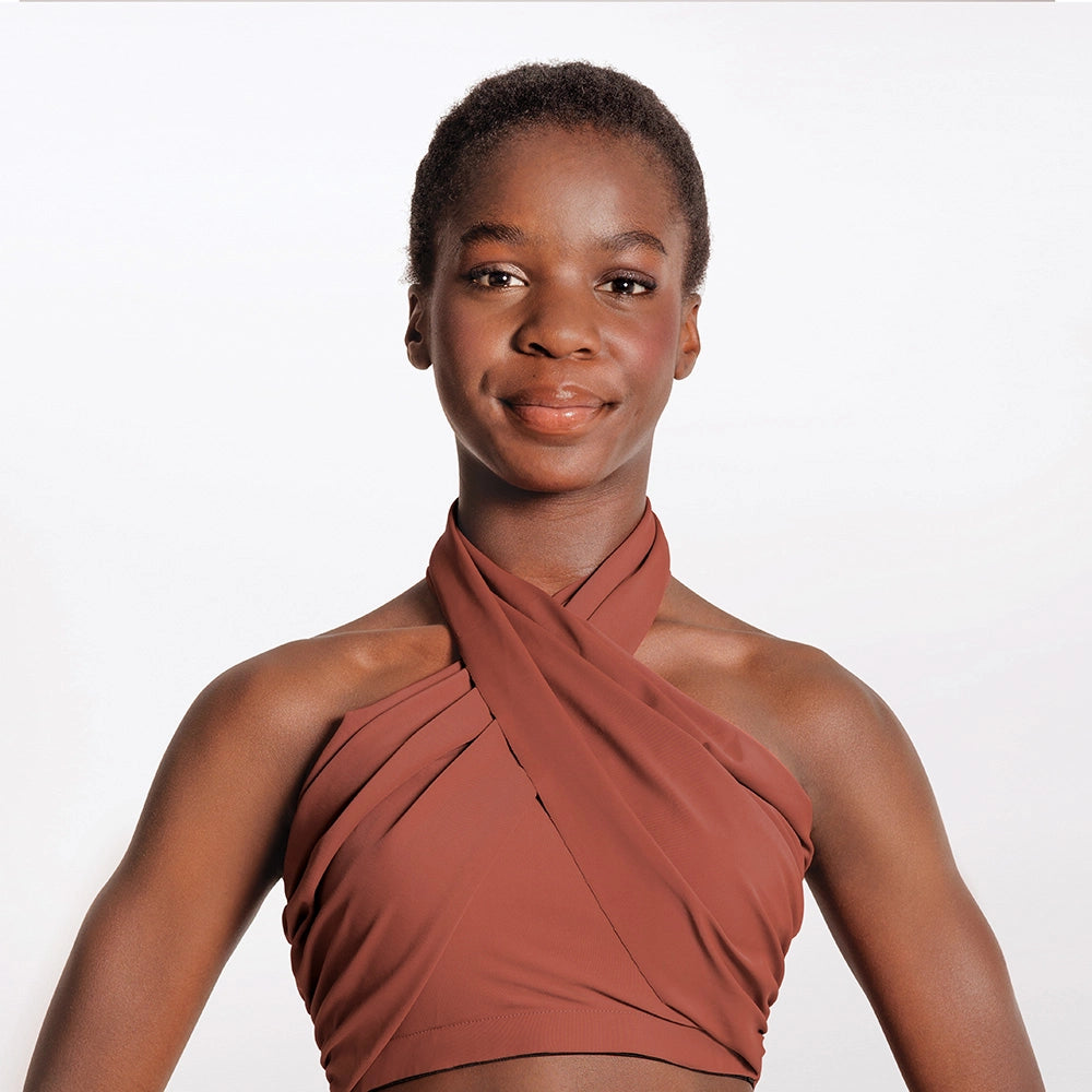 Woman wearing a brown halter top against a white background