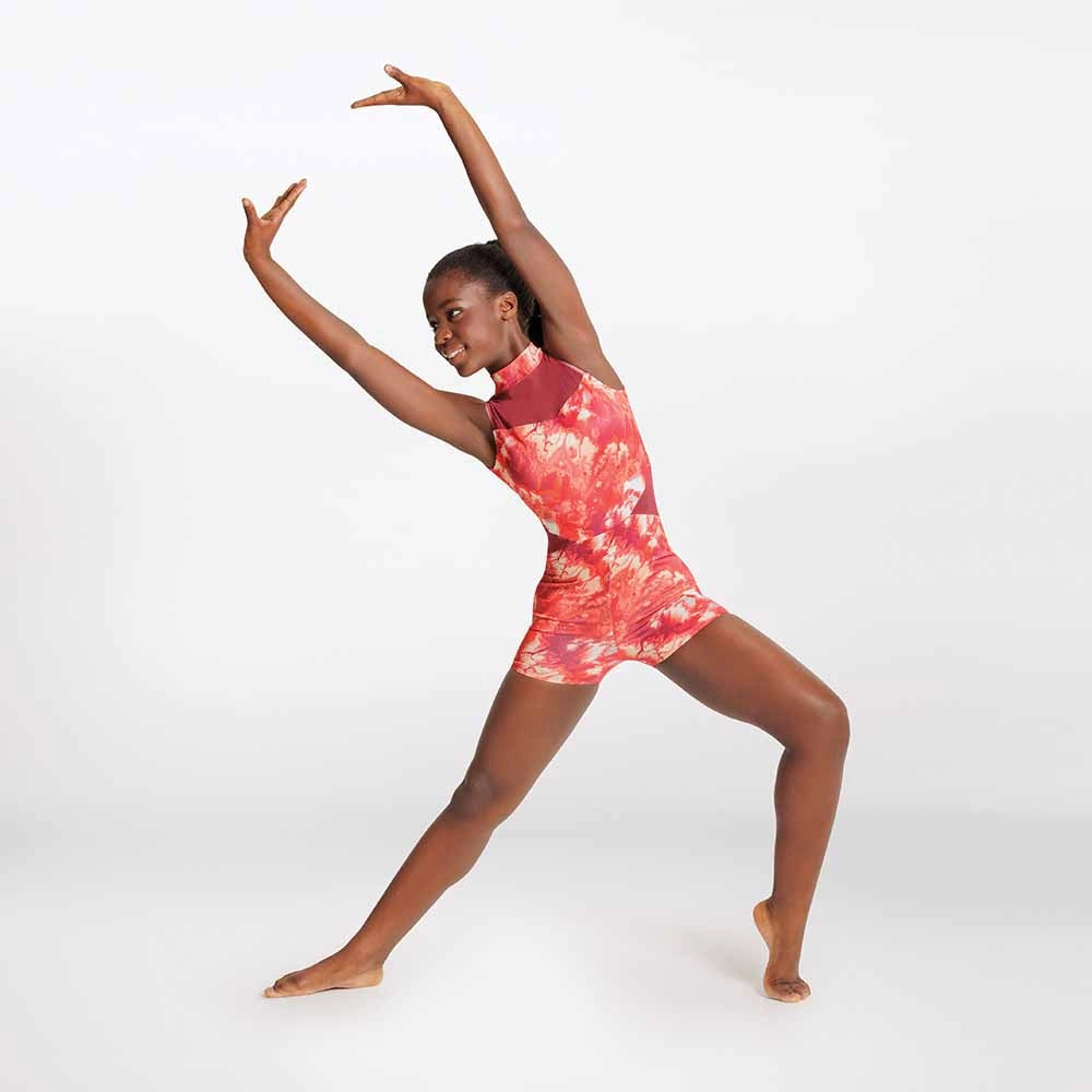 Person wearing a red and white tie-dye romper on a white background
