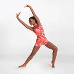 Person wearing a red and white tie-dye romper on a white background