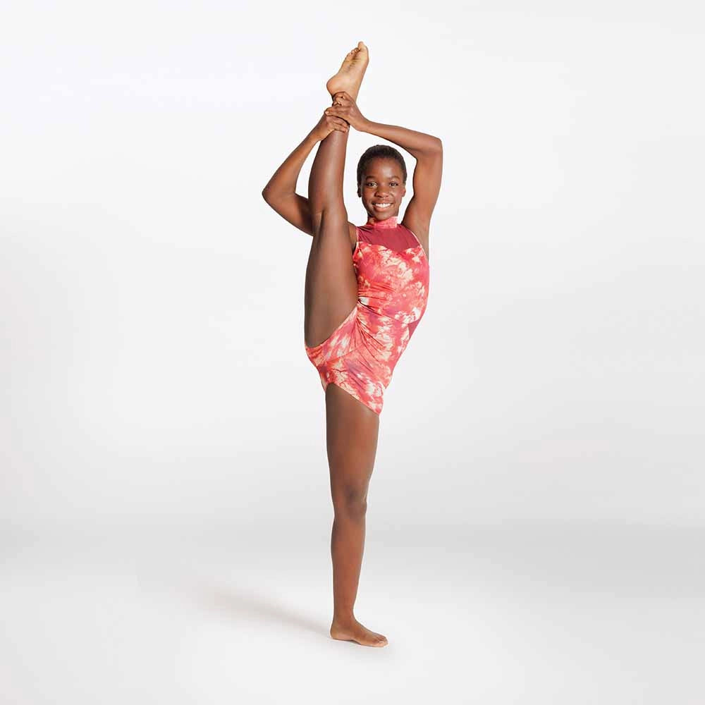 Person wearing a pink tie-dye swimsuit performing a split on a white background