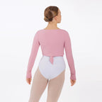 Person wearing a pink long-sleeve leotard and white bodysuit on a white background