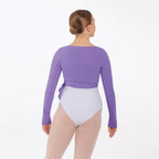 Person wearing a purple long-sleeve leotard and white shorts on a white background