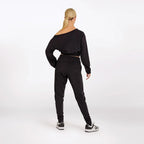 Person wearing a black outfit on a white background