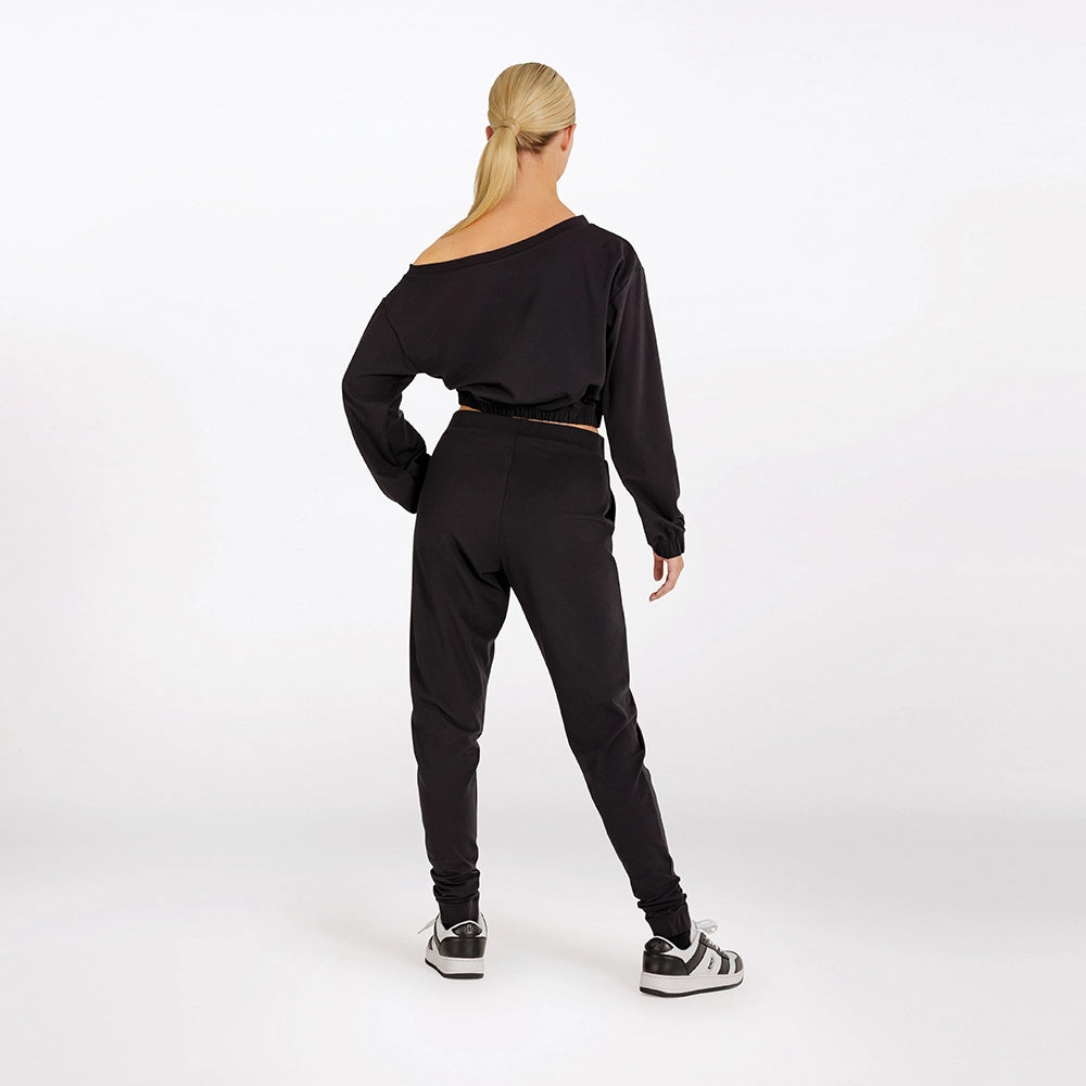 Person wearing a black outfit on a white background