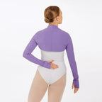 Person wearing a purple long-sleeve top over a white bodysuit on a white background