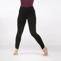 Person wearing black leggings on a white background