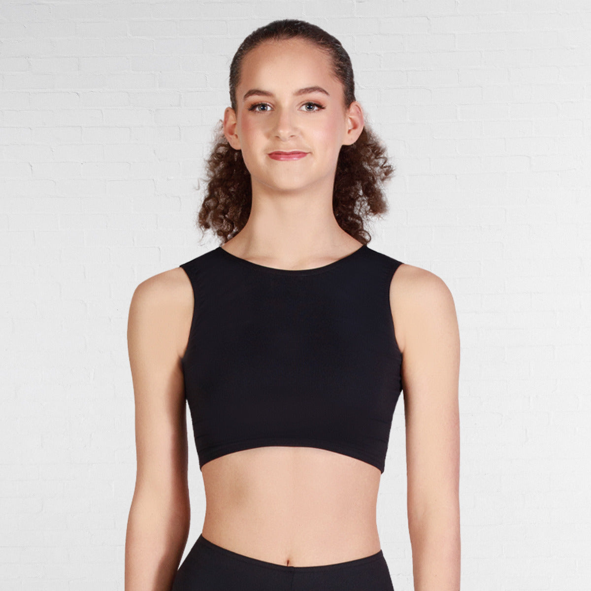 Person wearing a black sleeveless top against a plain background