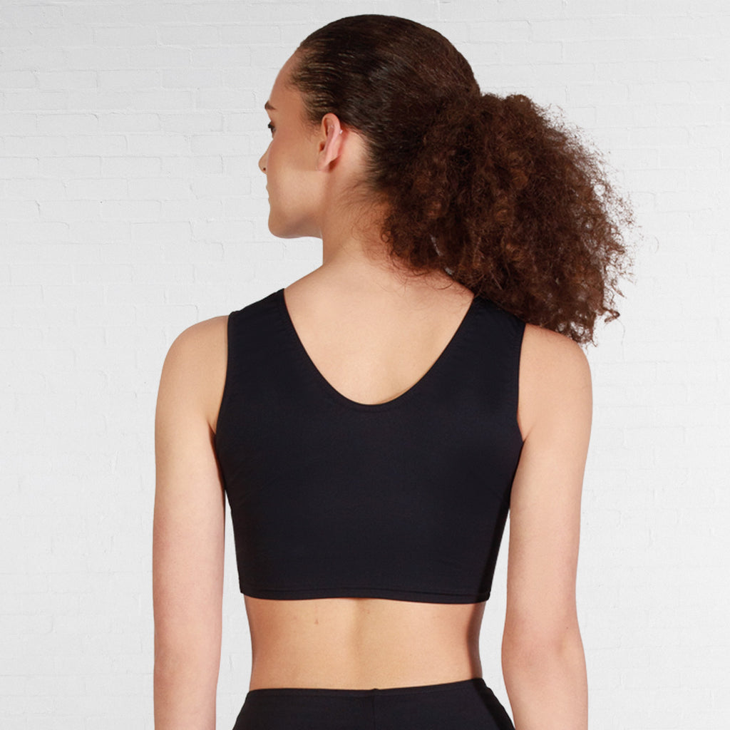 Woman wearing a black sports bra against a plain background