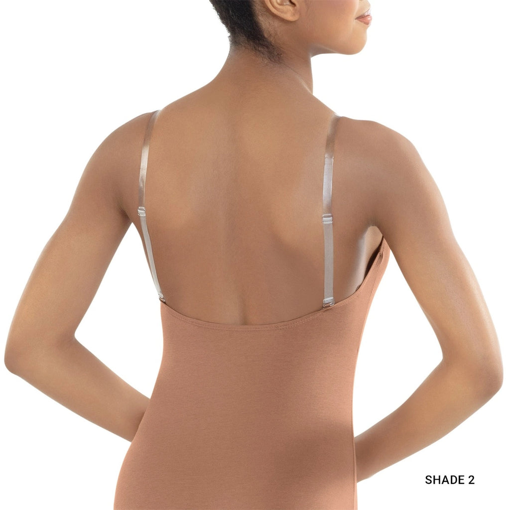 Woman wearing a beige bodysuit with thin straps on a white background