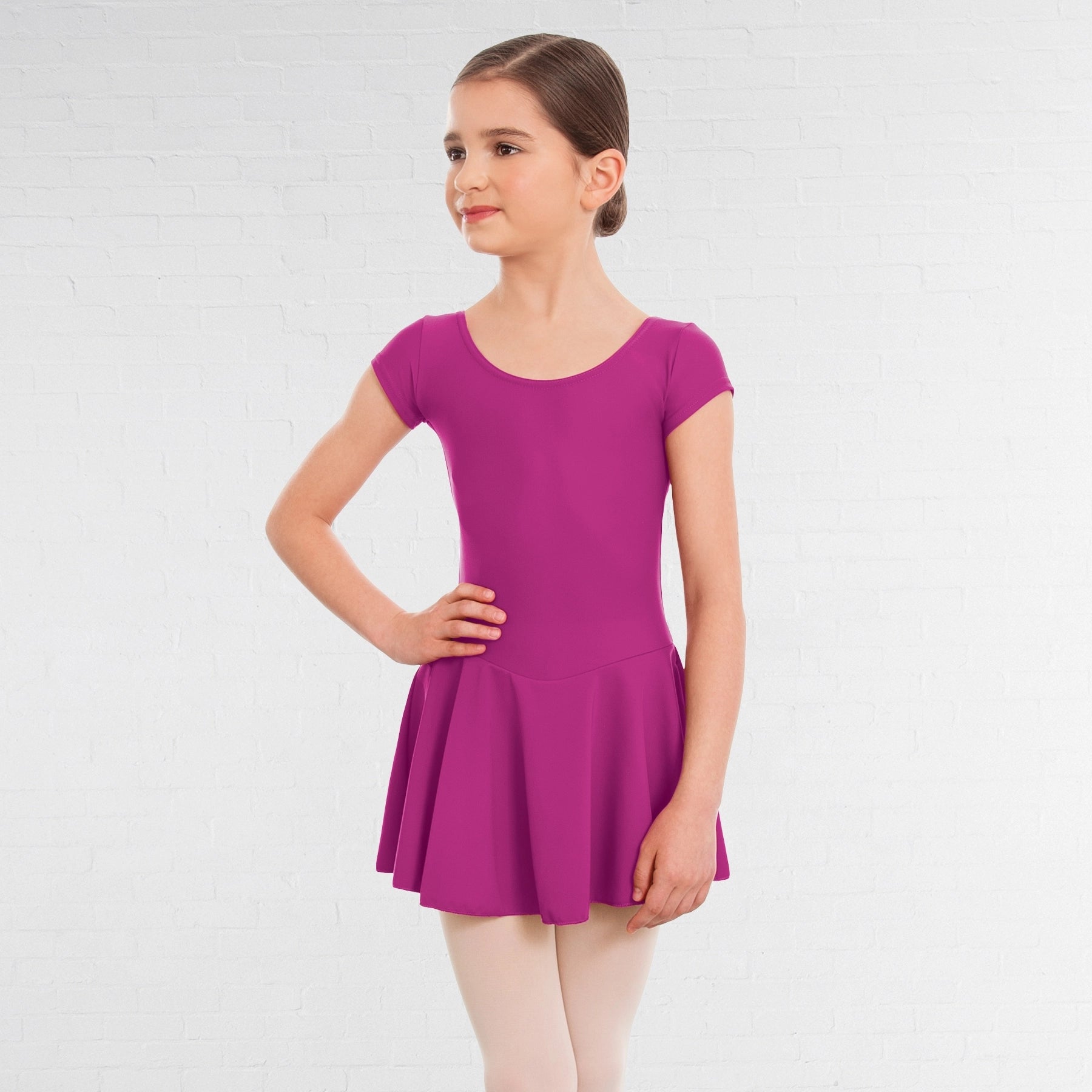 Young girl wearing a purple dress on a white background