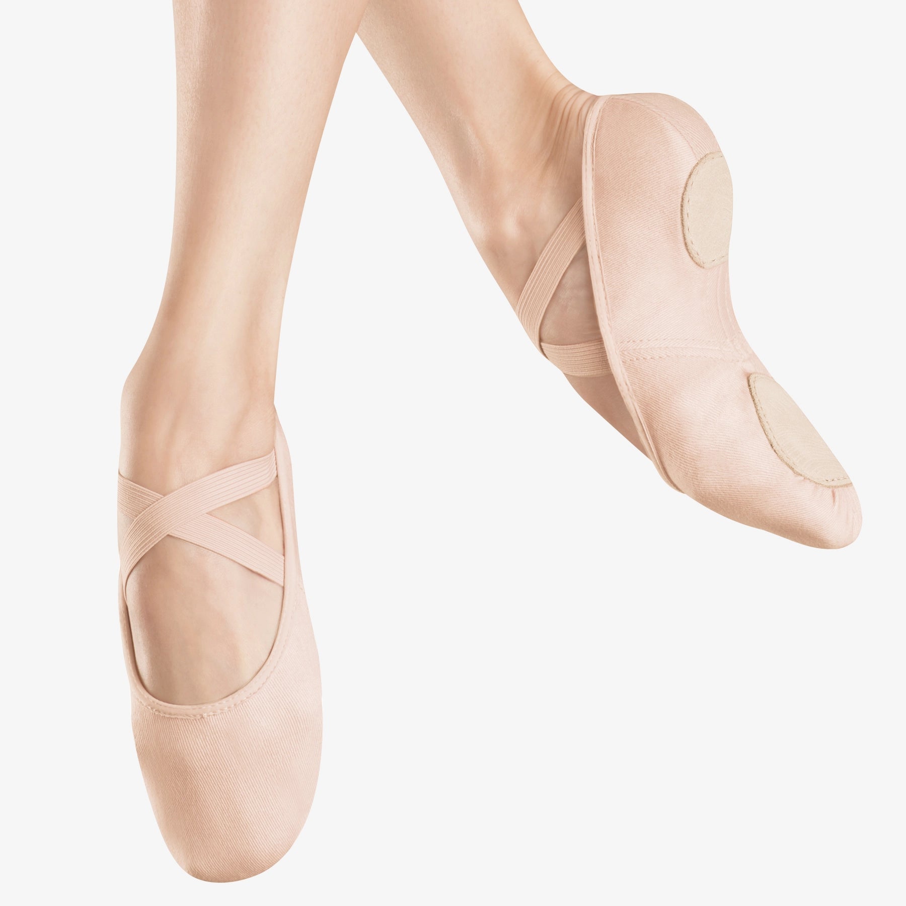 Ballet shoes worn on a white background