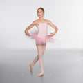 Ballerina in a pink tutu posing on a plain background