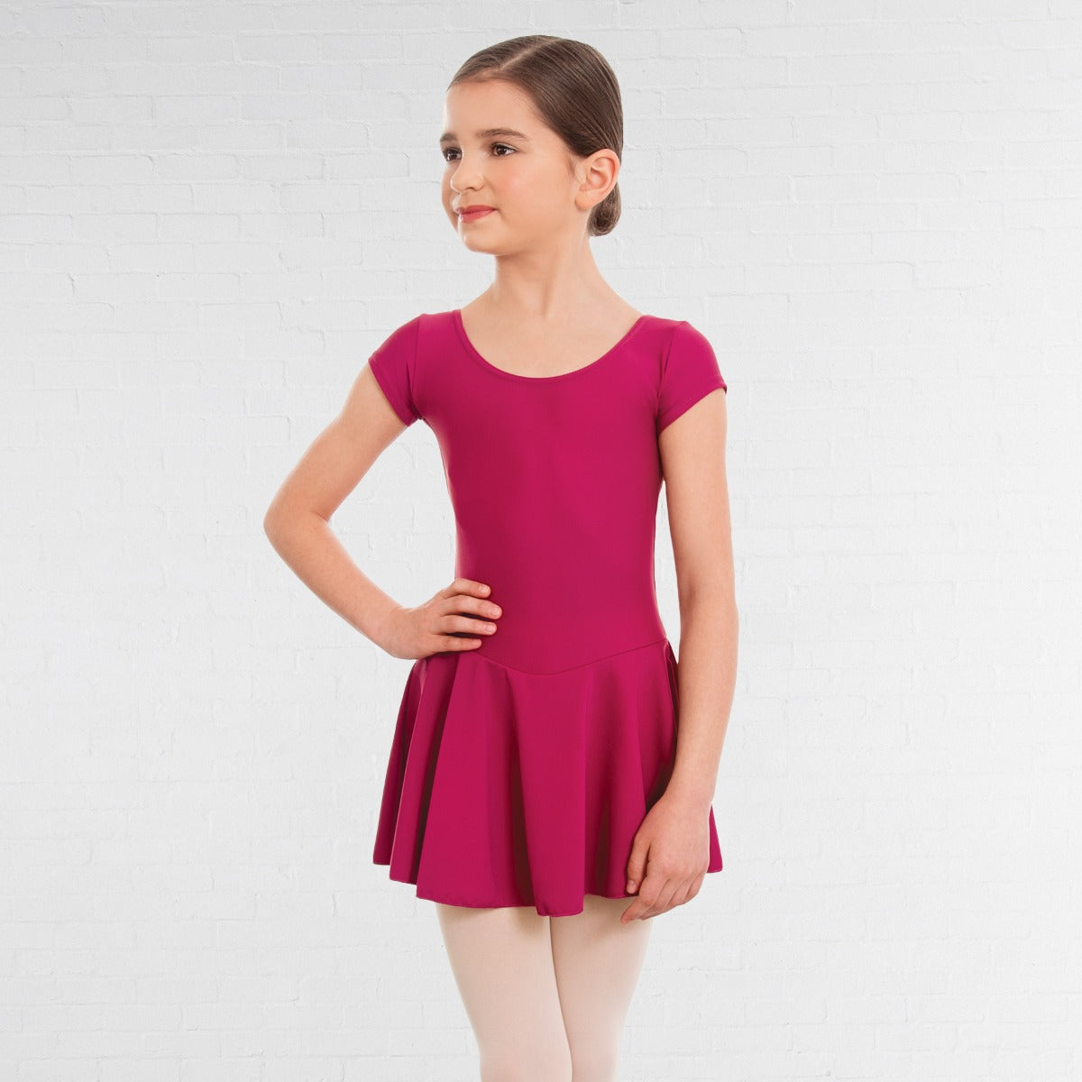 Young girl wearing a pink dress on a white background