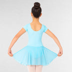 Person wearing a light blue dress against a plain background