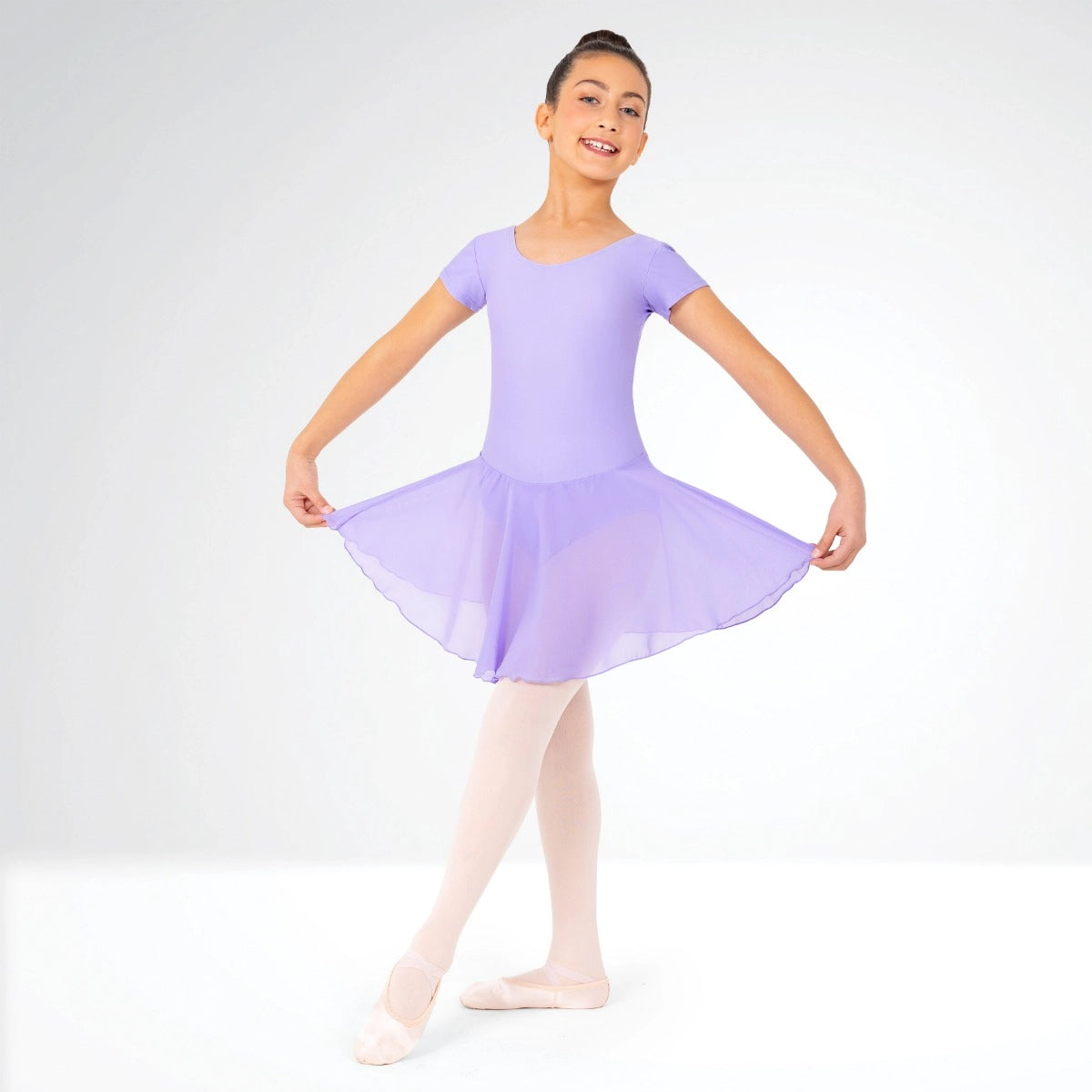 Young girl in a lavender ballet outfit on a white background