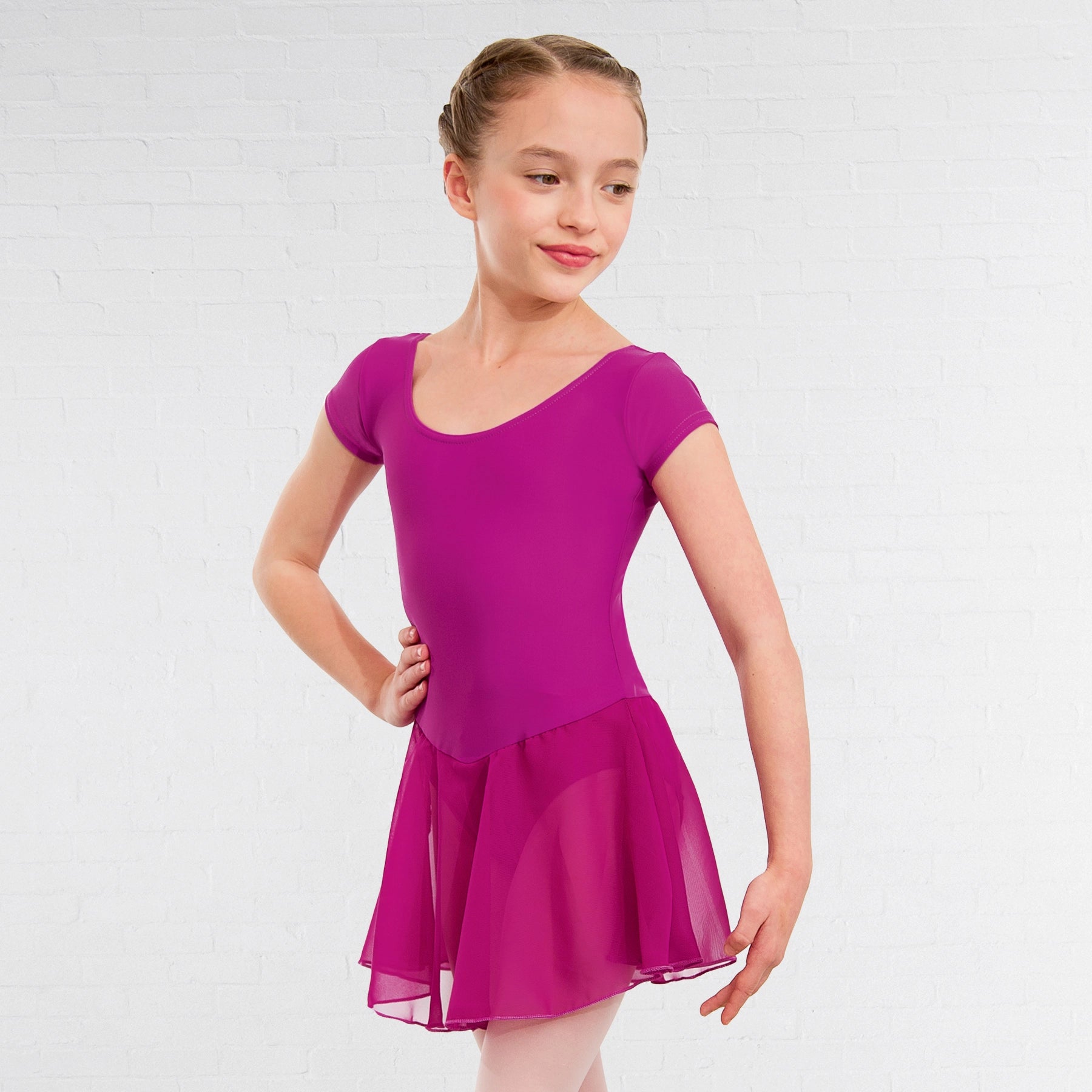 Young girl wearing a purple dress on a white background
