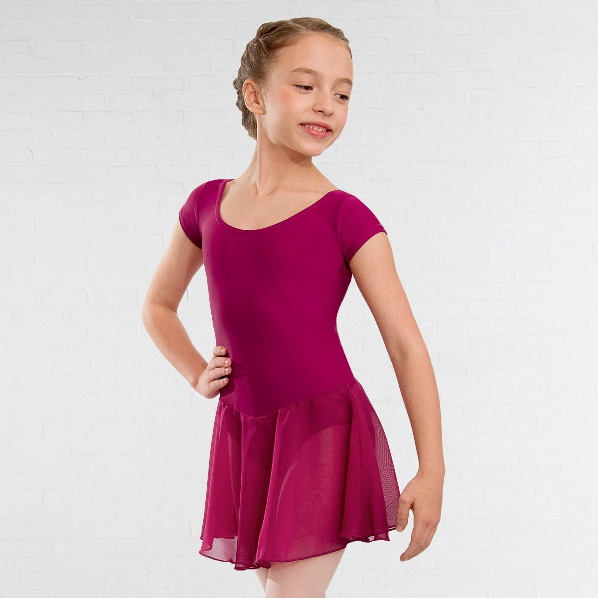 Young girl wearing a magenta dress on a white background