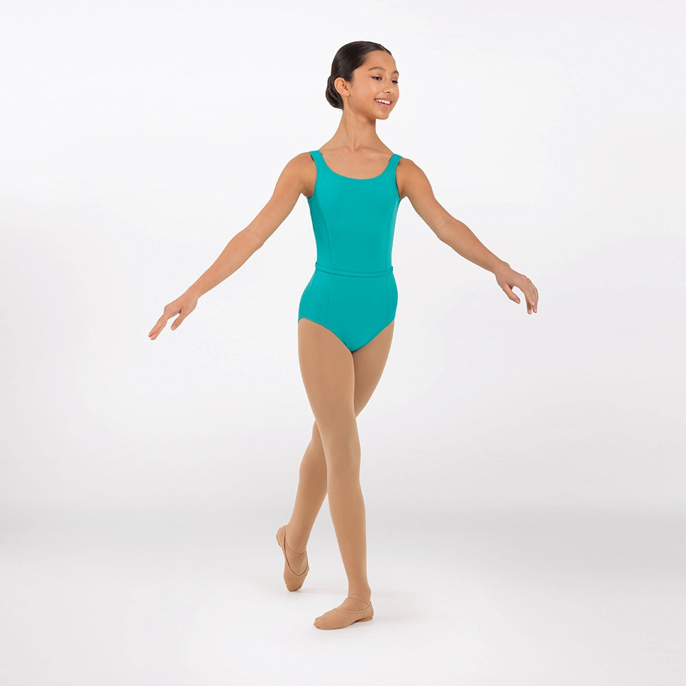 A young girl dancer posing in a bright turquoise sleeveless leotard and nude tights against a clean white studio background.
