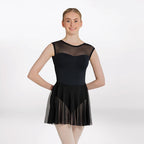 Woman wearing a black ballet dress with sheer overlay on a white background