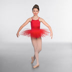 Young girl in a red ballet outfit posing on a gray background