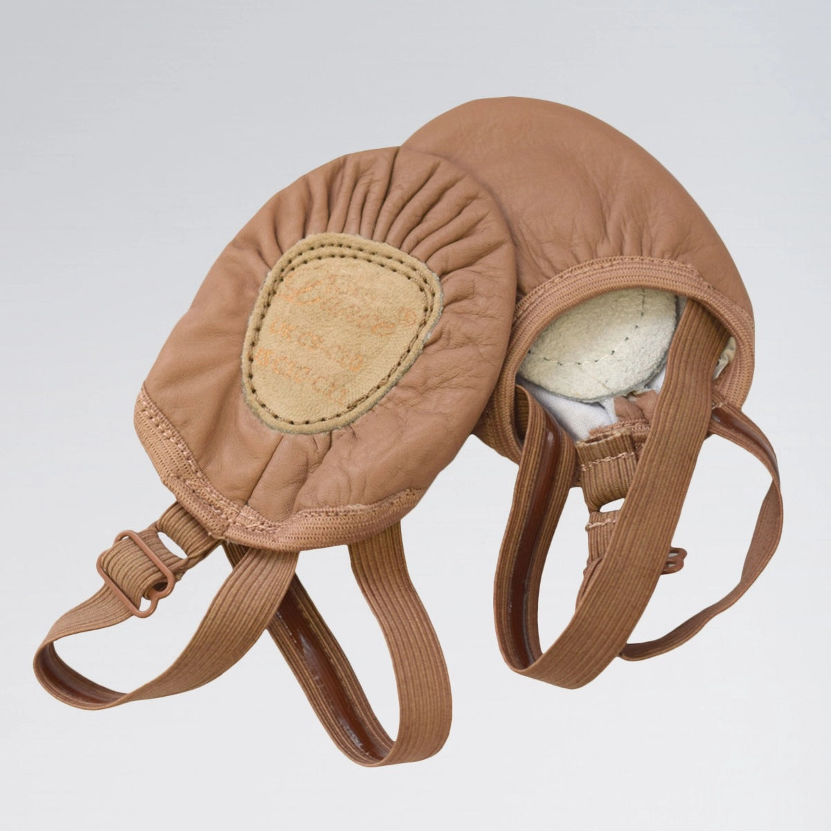 Brown leather bridle with straps on a light gray background