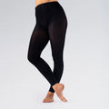 Black leggings worn by a person on a light gray background