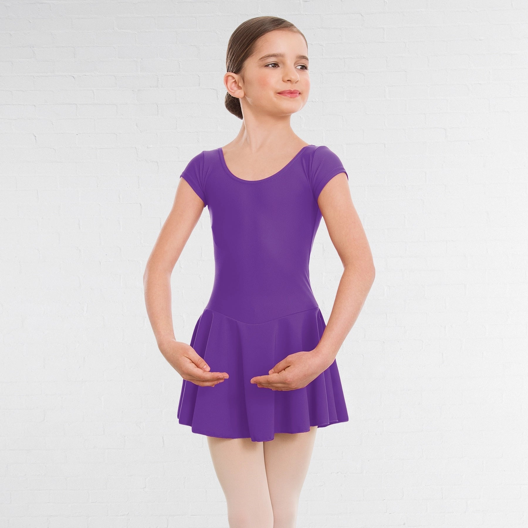 Young girl wearing a purple dress on a white background