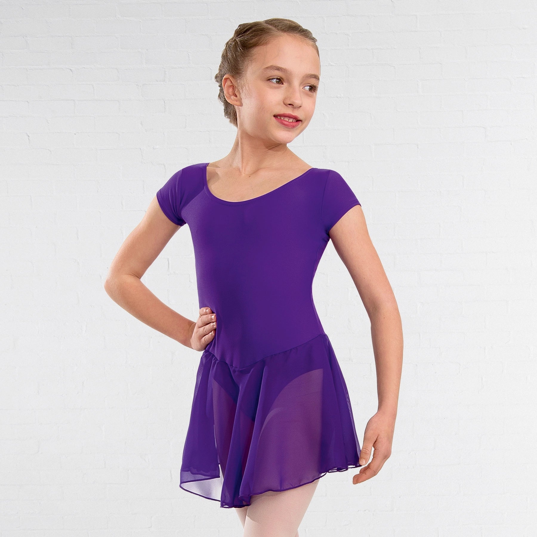 Young girl wearing a purple dress on a white background