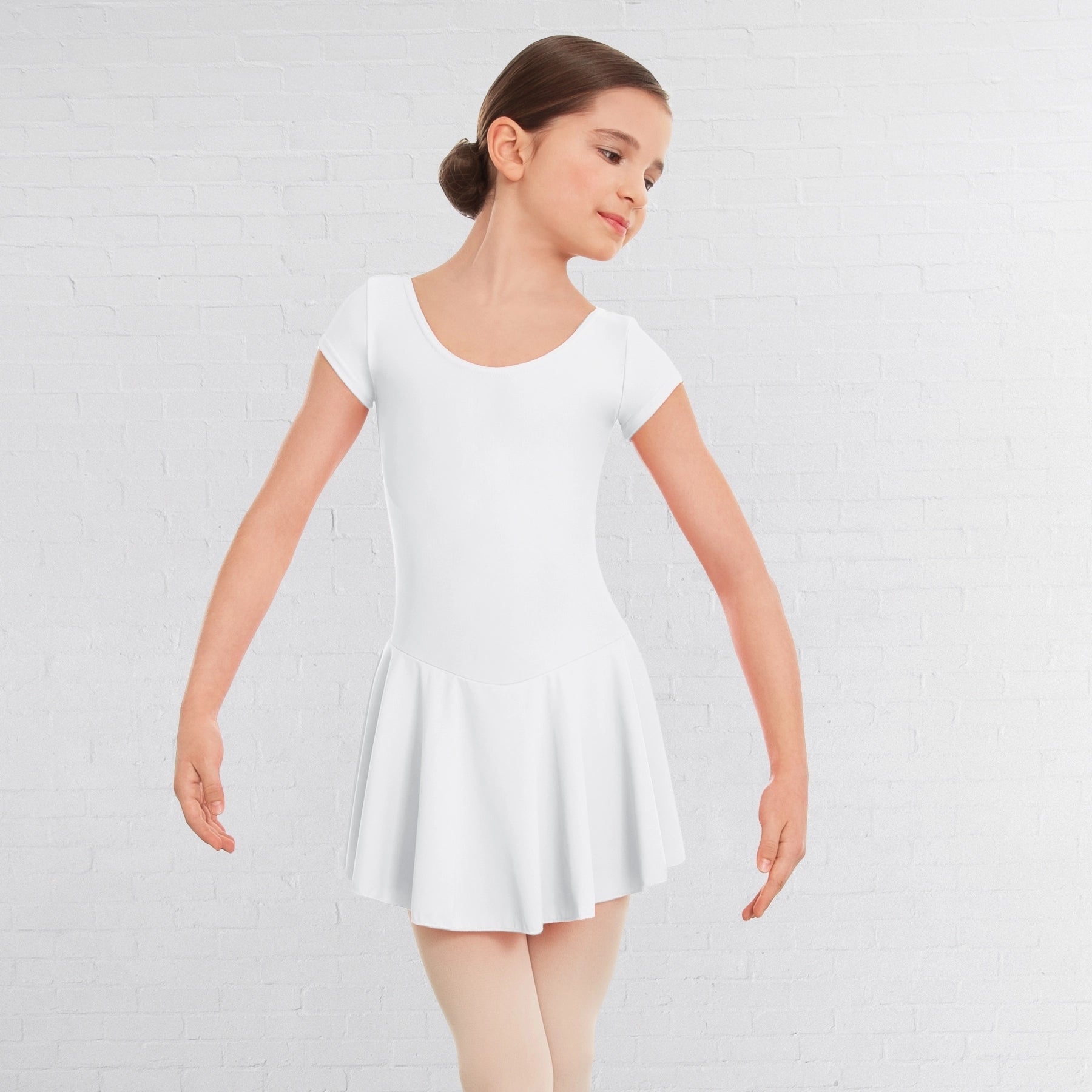 Young girl wearing a white dress against a light gray background